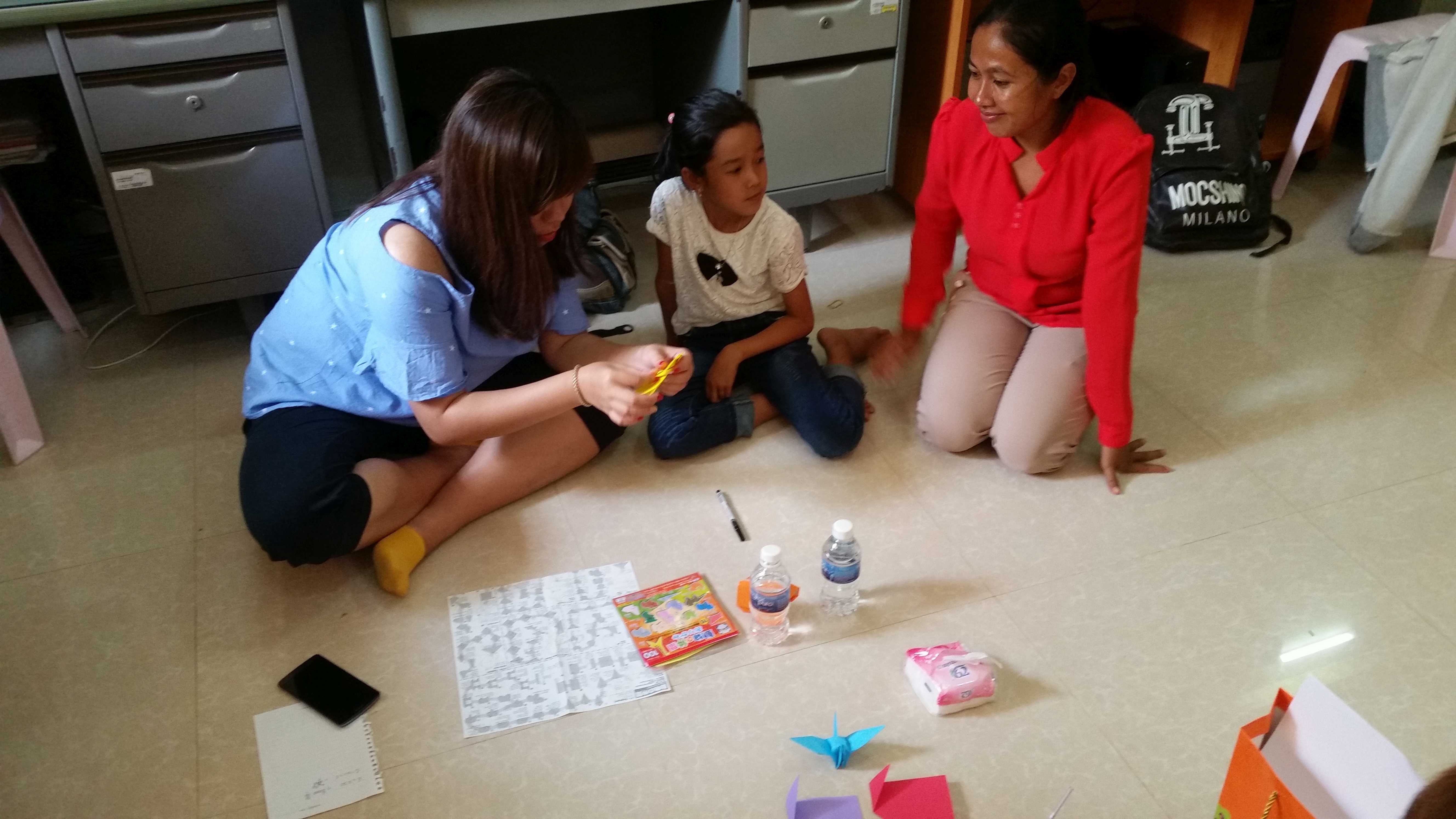 Elsie and her sponsored child doing arts and crafts