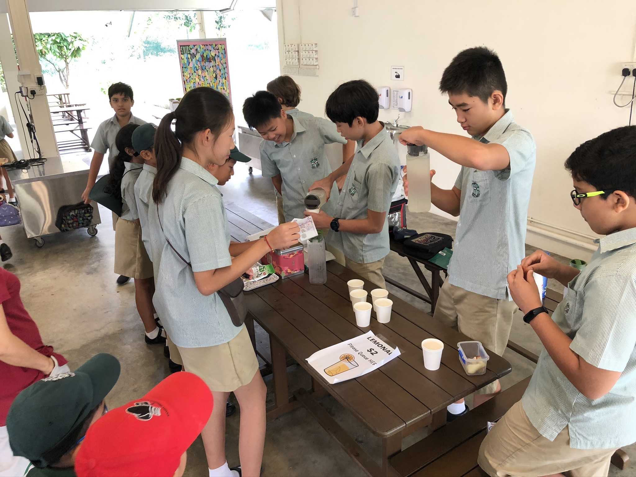 My friends and I preparing lemonade for our classmates!