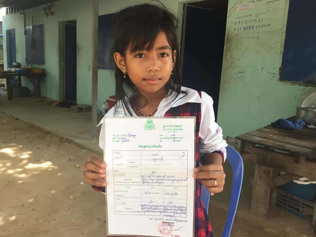 A Cambodian child with her birth certificate