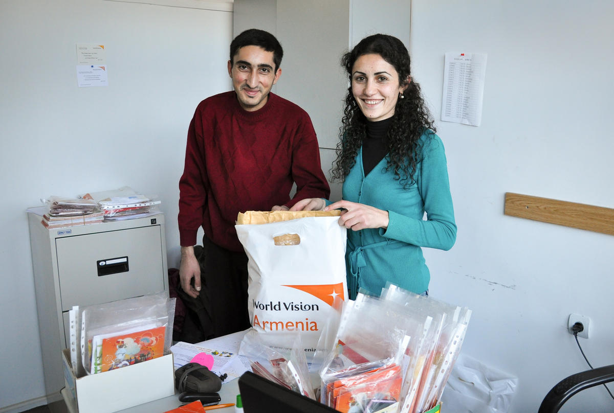 World Vision staff sprting through the letters