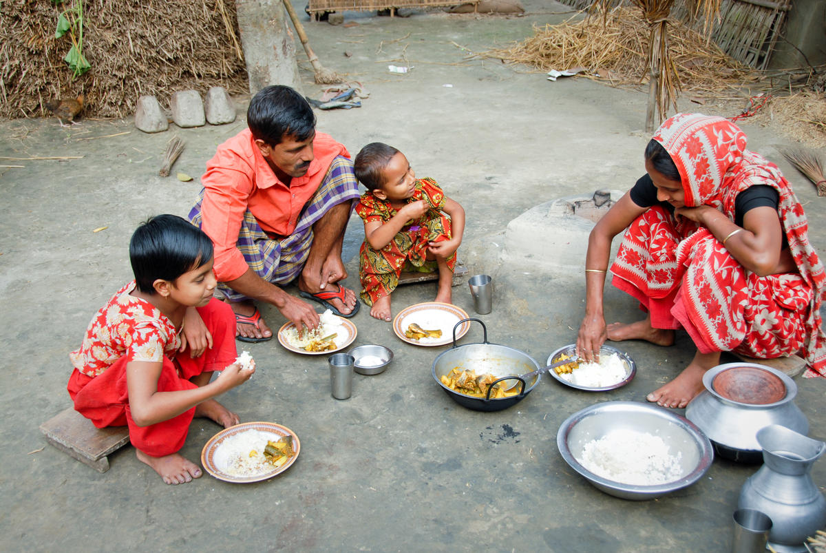 A Bangladesh World Vision sponsored child and her family having lunch at home