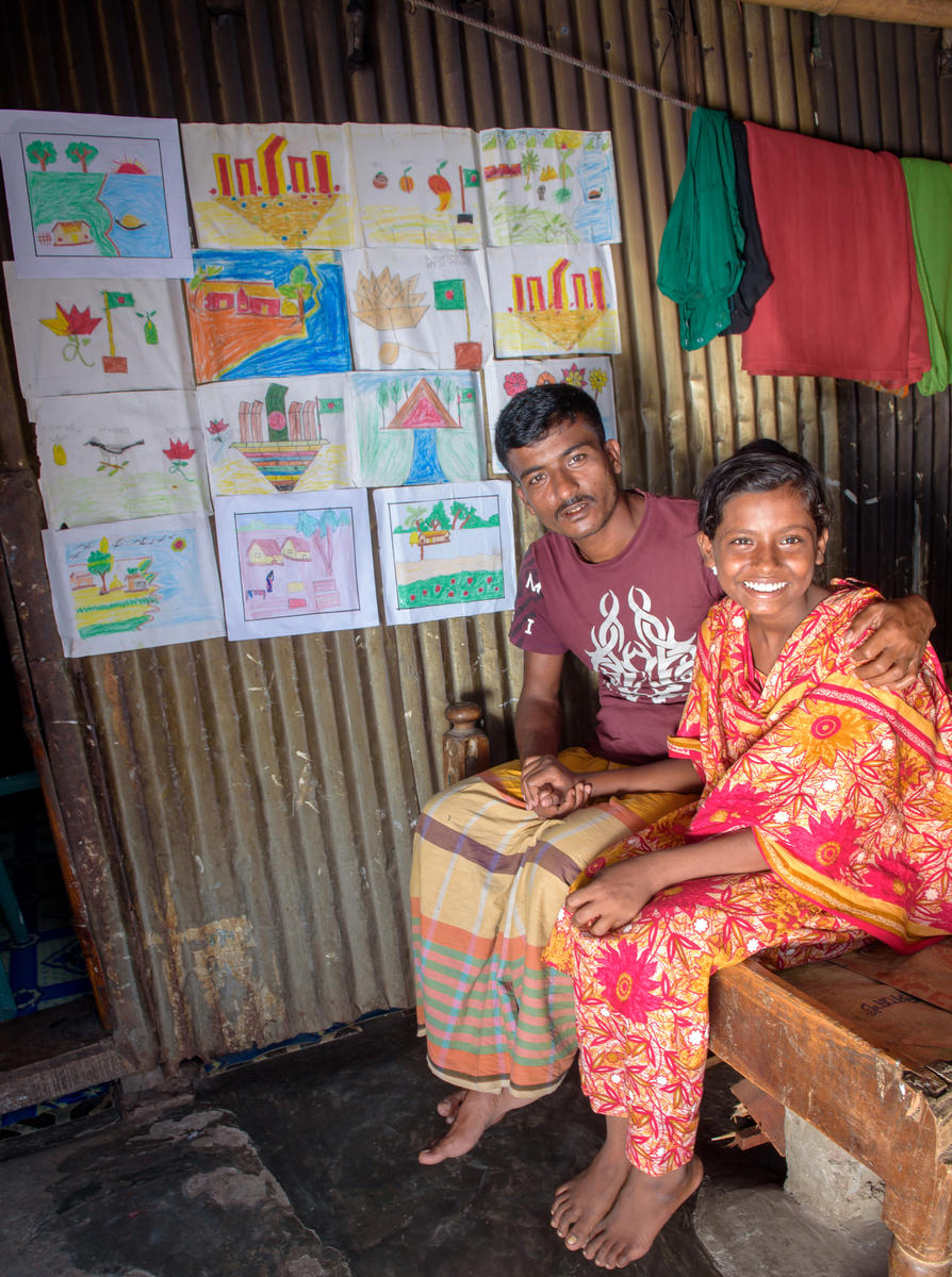 A World Vision Beneficiary and her father in Bangladesh's traditional outfits 