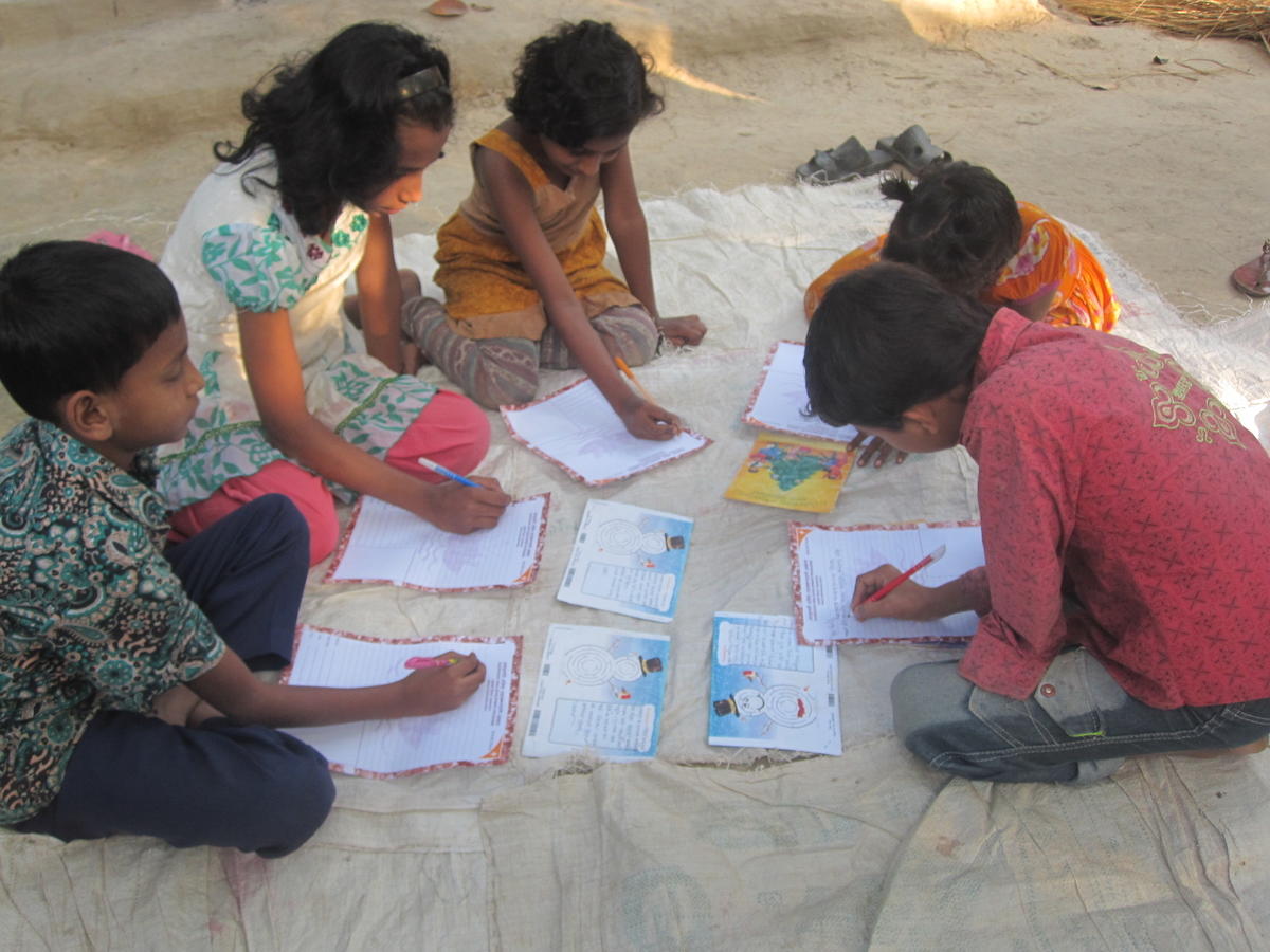 Children working on their reply letters as a group