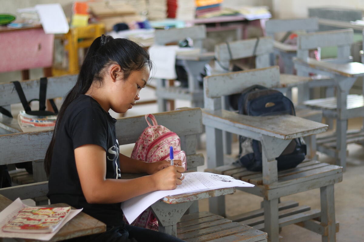 World Vision sponsored child writing a letter to her sponsor