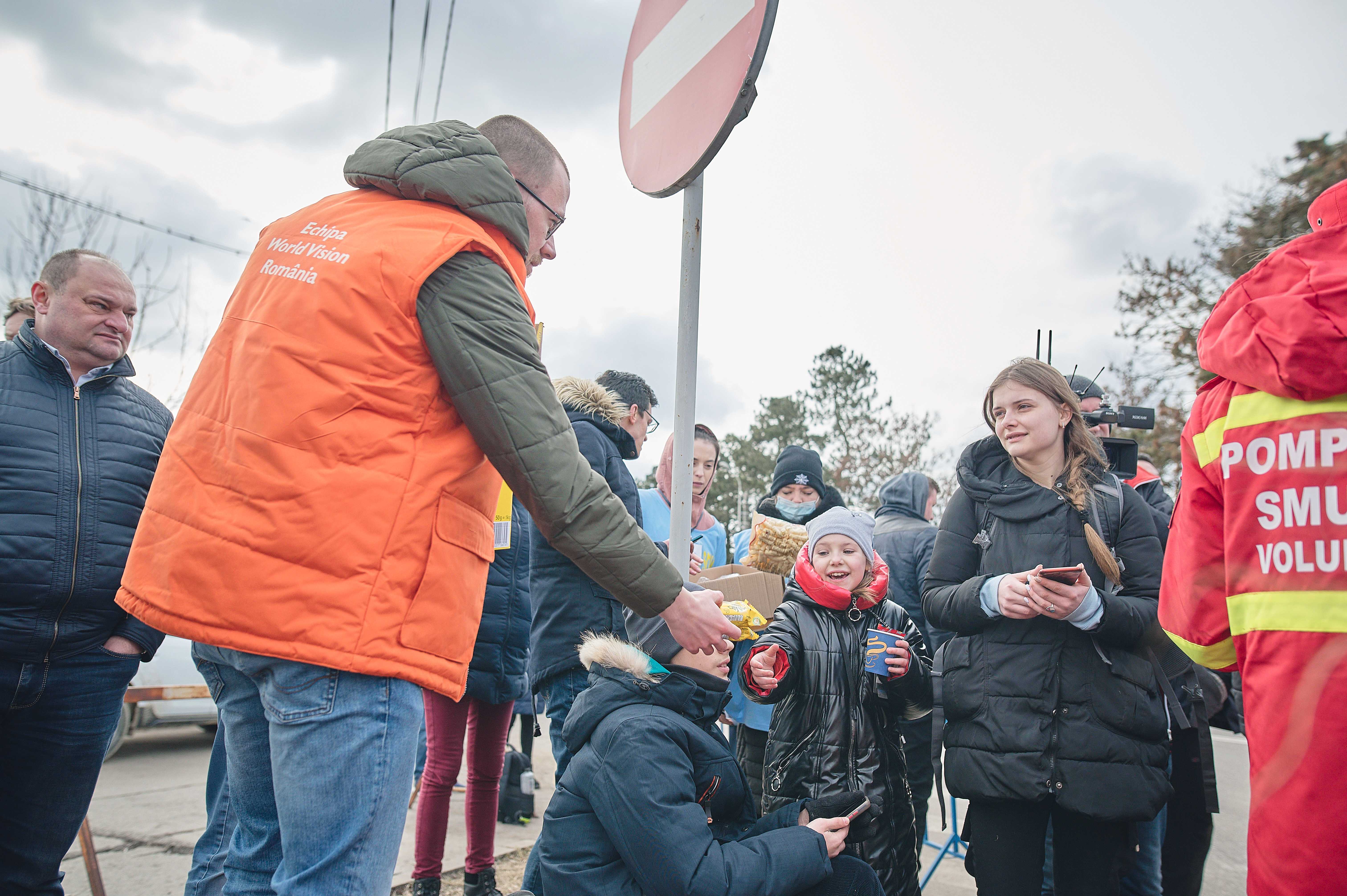 WV Romania staff members Nicoleta Popa and Alberto Roca with Ukrainians on the border with Romania called Vama siret.