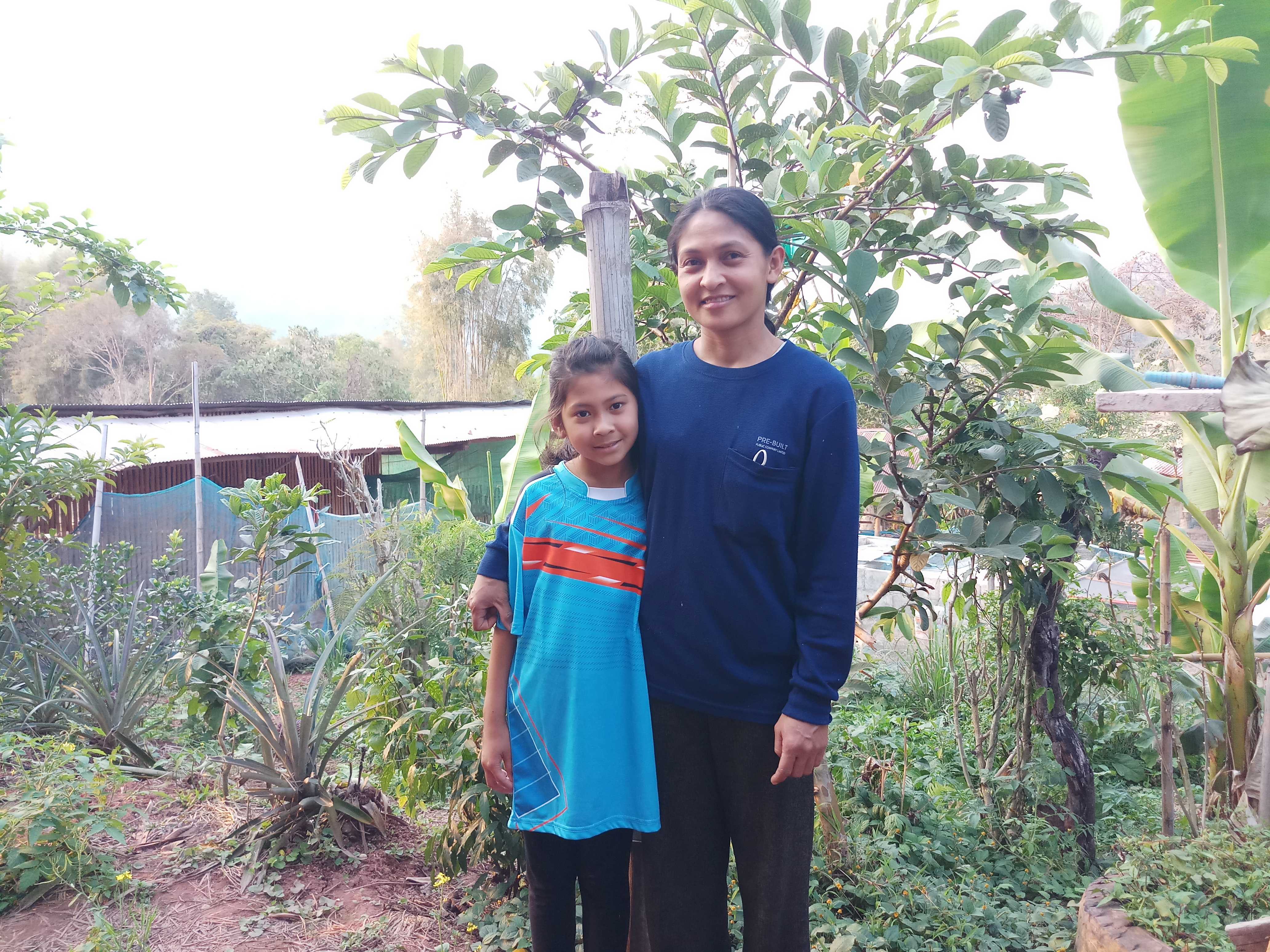 Taengmo and her mum in their home garden