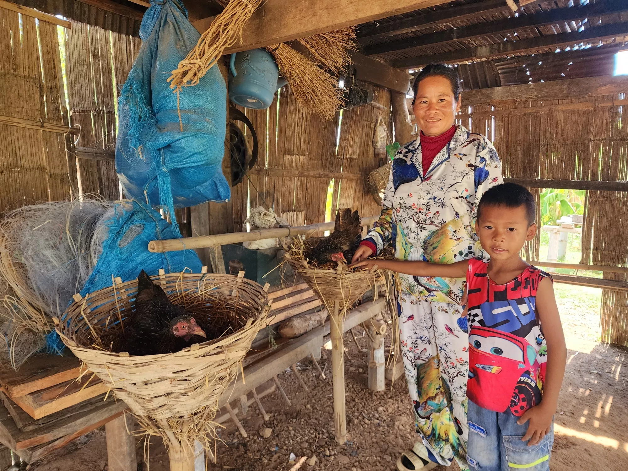 Sophit and his mother is checking hens laying on their eggs