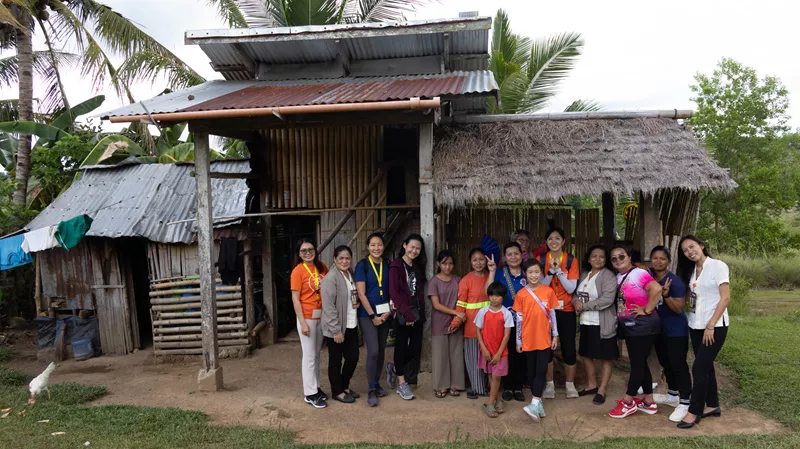 Jessica (fourth from left) and the child sponsors visiting the Placida family to understand their living conditions and challenges faced
