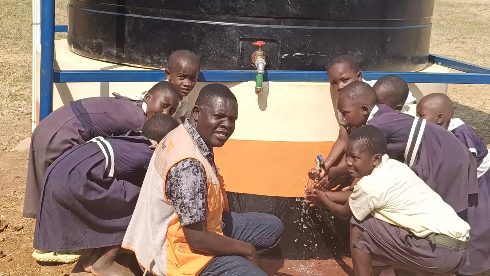 Learners from Busembe Primary School enjoying clean water