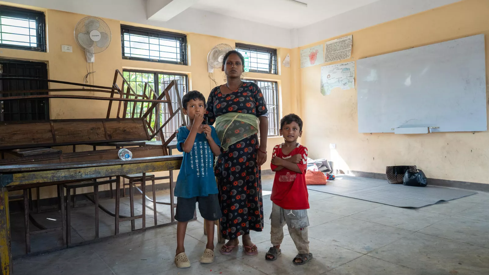 Urmila with her two sons at a temporary evacuation centre in Nuwakot