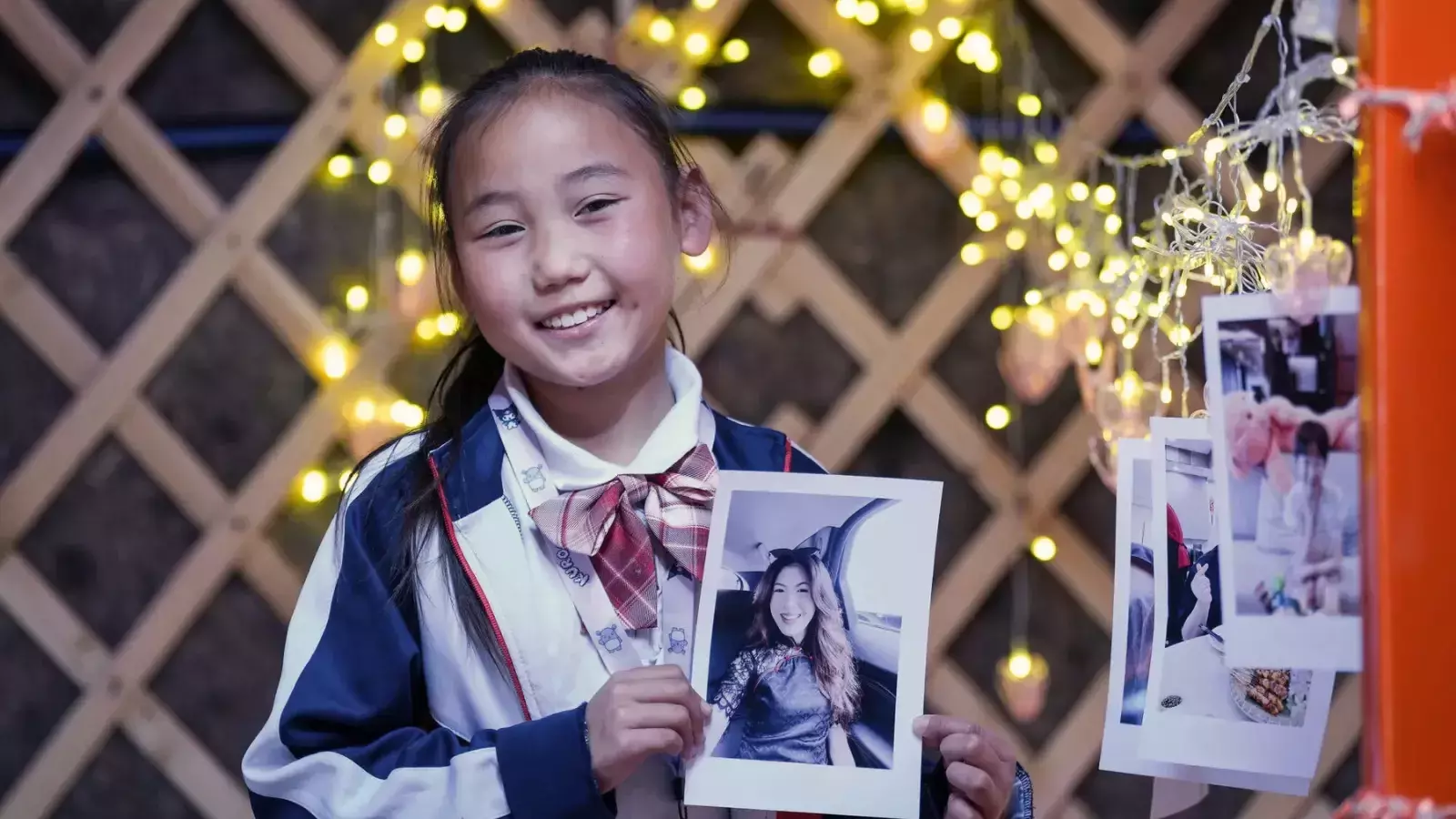 Child from Mongolia holding her sponsor's photo