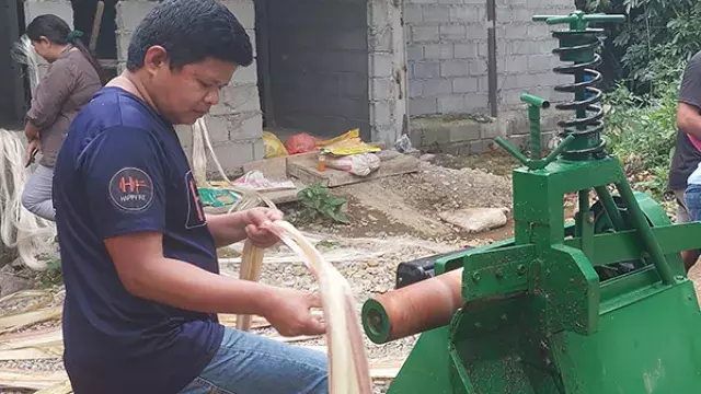 Person operating fiber machine near construction site