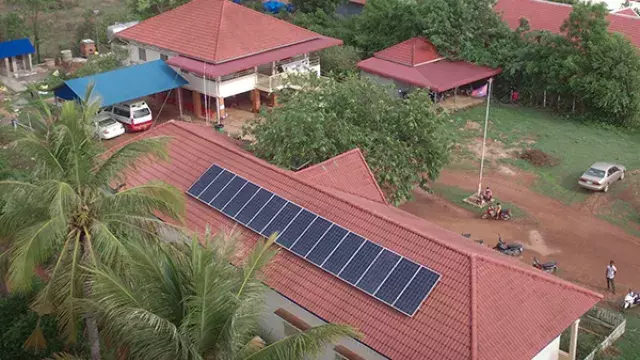 House with solar panels on red‑tiled roof