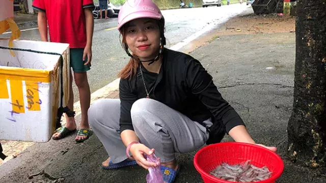 Person with basket of seafood on roadside