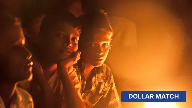 Children illuminated by warm light with dollar match label