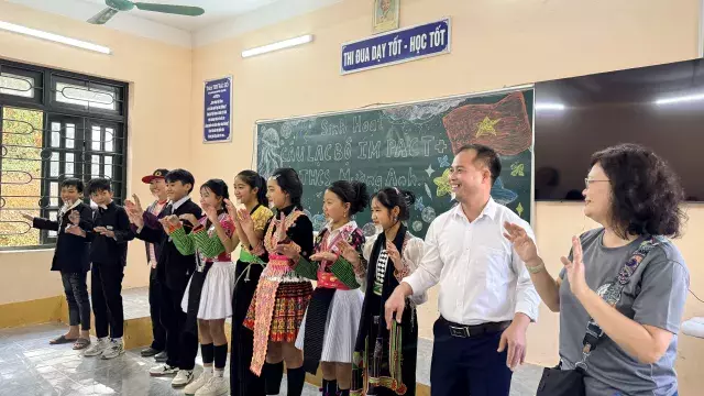 Students and adults at an IMPACT+ club activity.